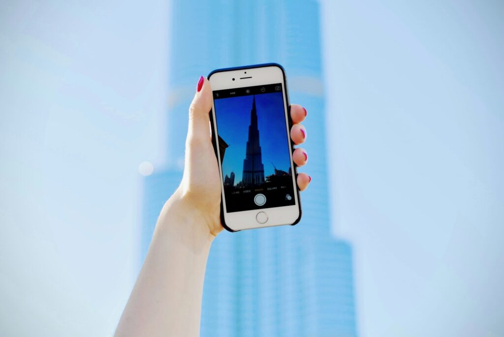 Content creator photographing the Burj Khalifa on a smartphone for an influencer marketing campaign in Dubai