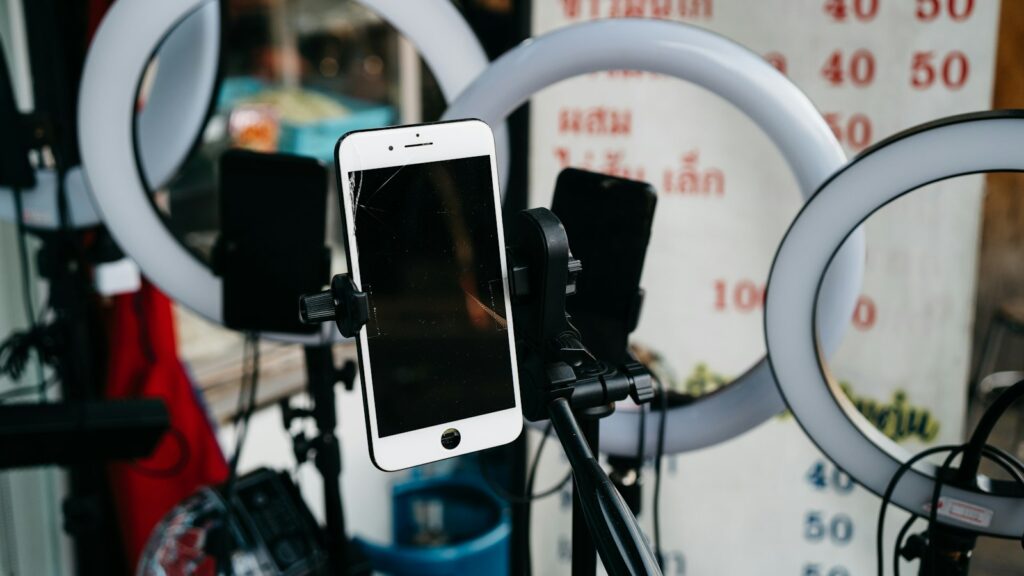 Phone on a tripod set up to film promotional content, for a guide to the UAE Advertiser Permit for influencers and brands
